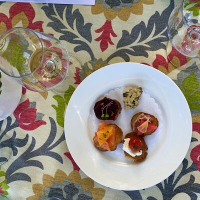Decorative tablecloth with appetizers and wine glasses