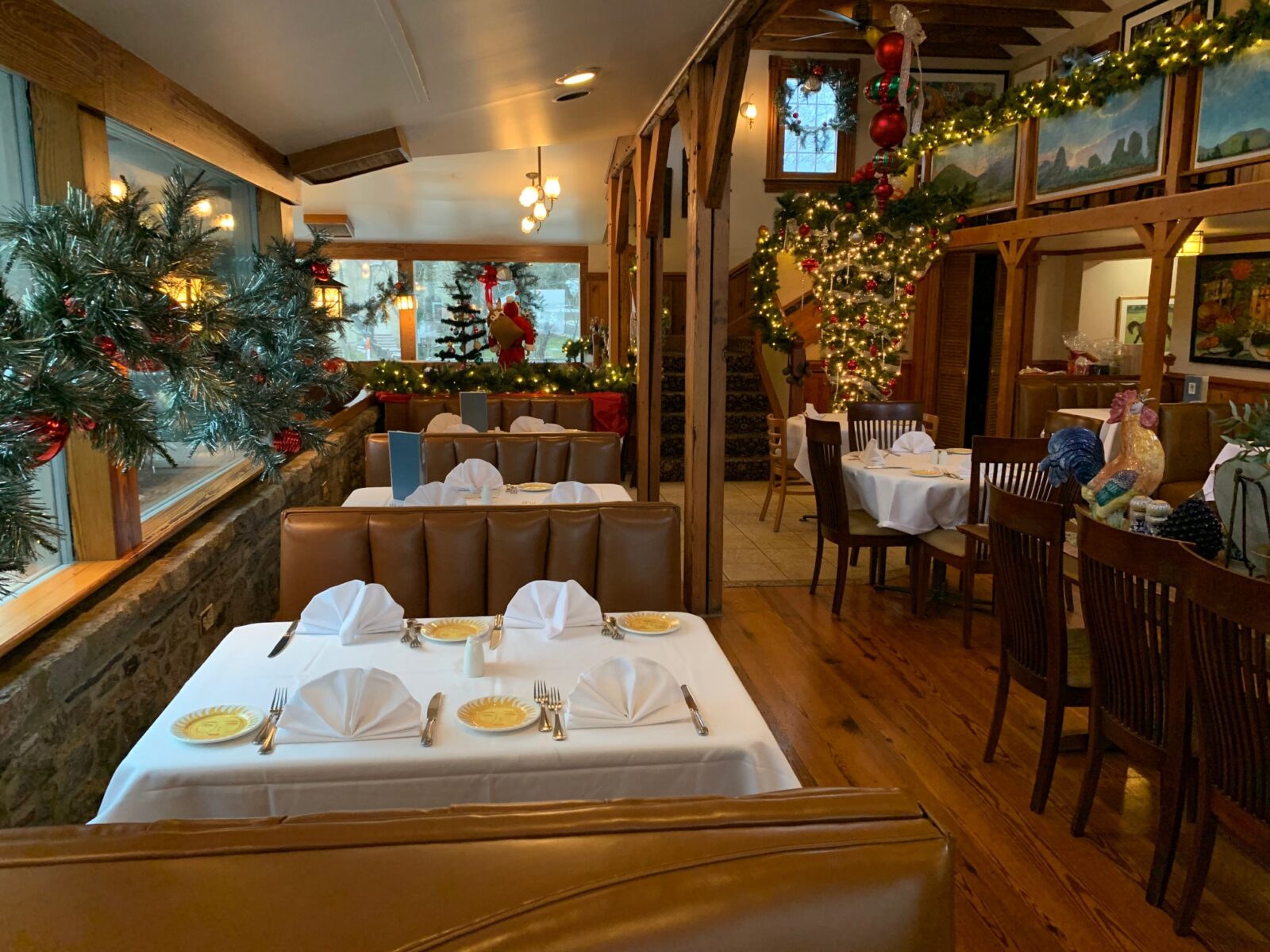 View of dining room with Christmas trees, garland, and lights