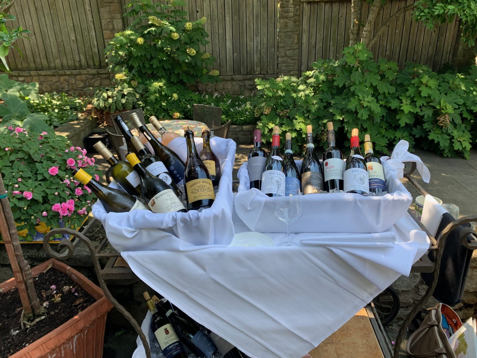 Wine displayed outside with greenery and flowers