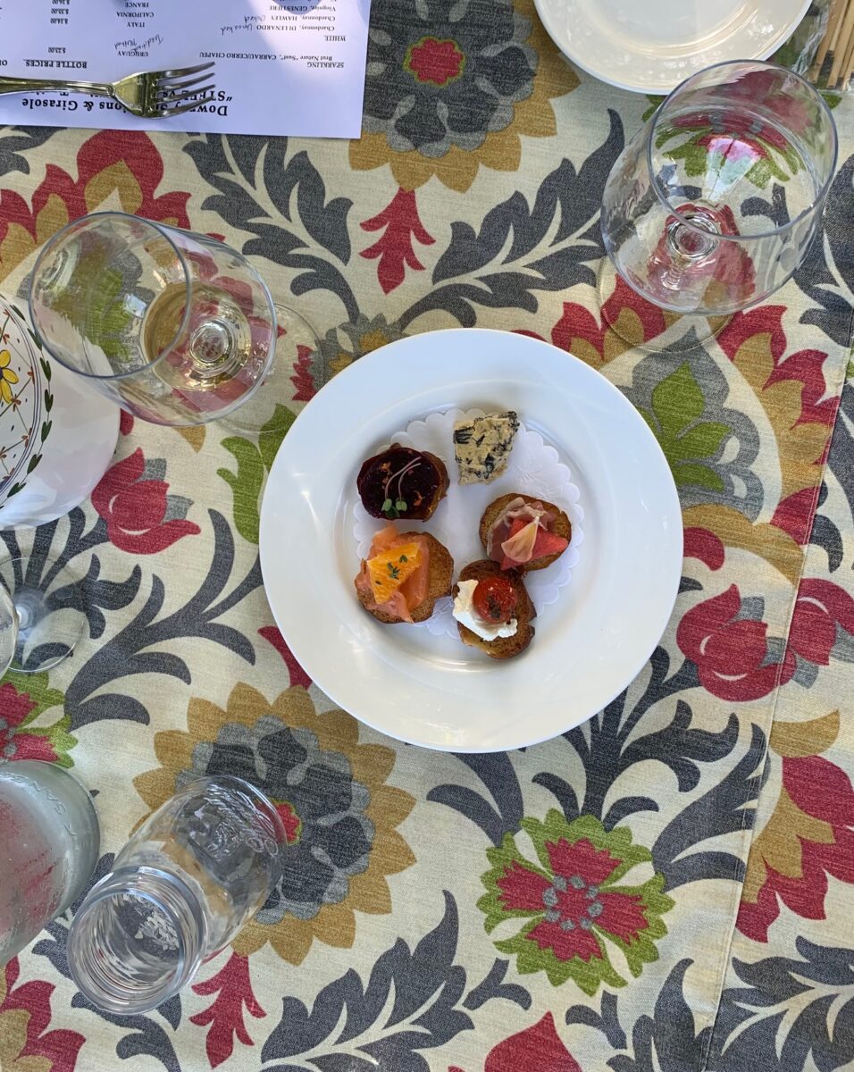 Plate of appetizers with glasses of wine