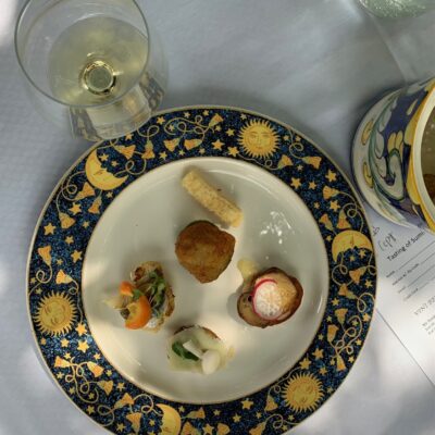 Plate of small bites with glass of wine