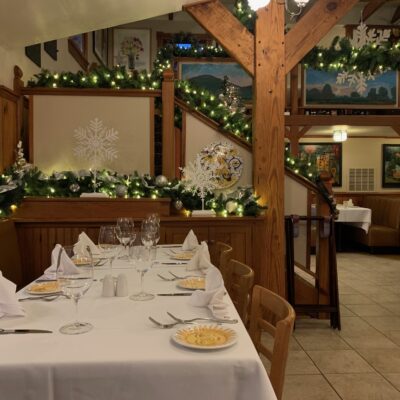 Long table surrounded by Holiday decorations of snowflakes and garland