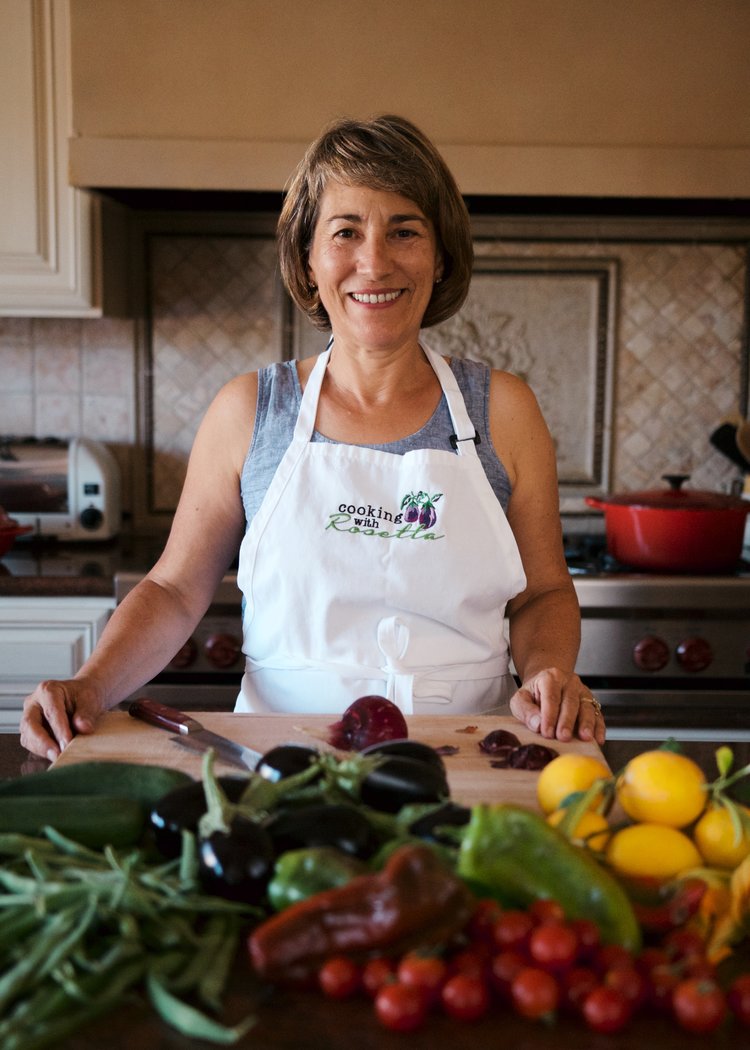 Author Rosetta Constantino in her kitchen with a mound of fresh ingredients