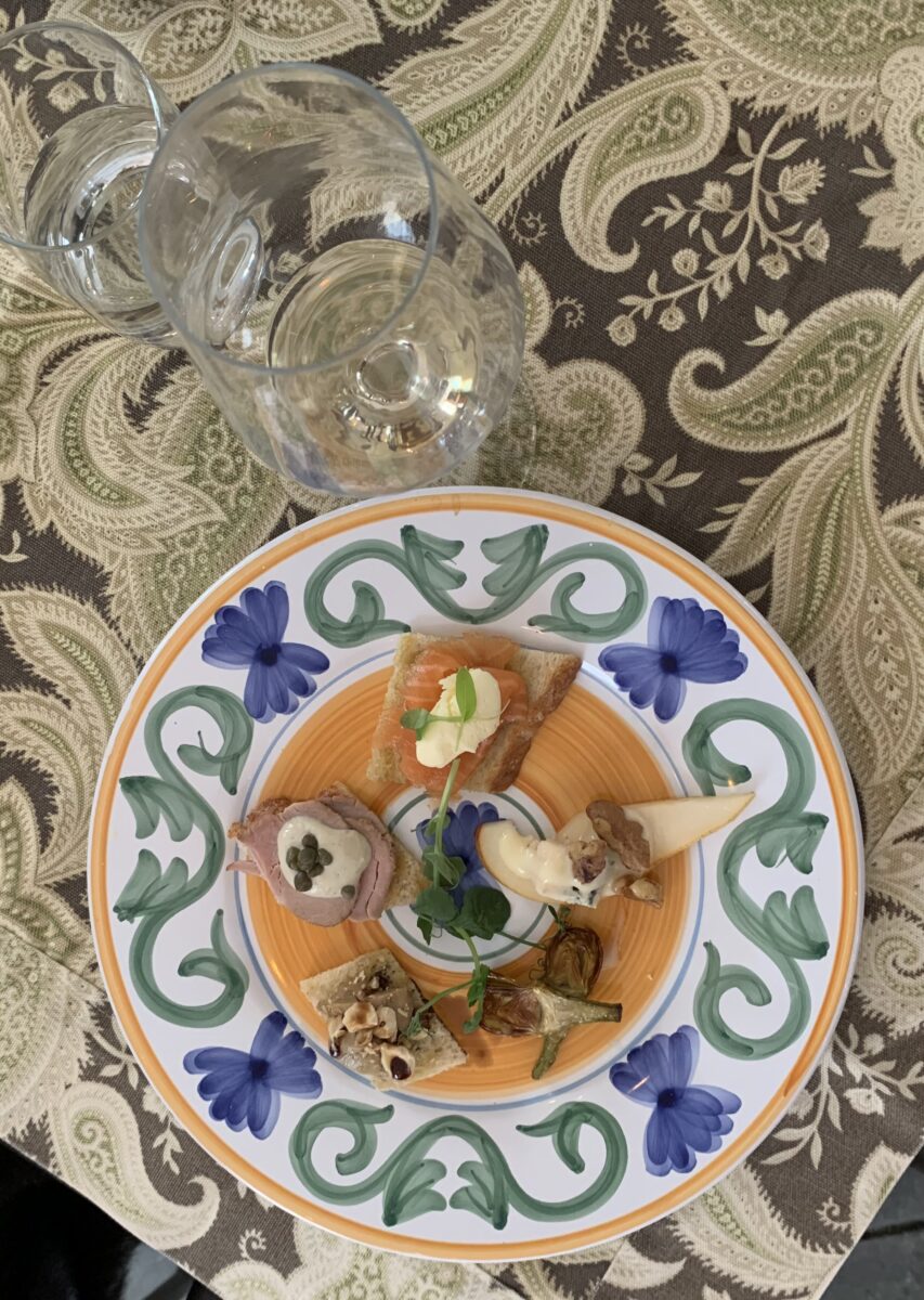 Plate of mixed appetizers accompanied by wine