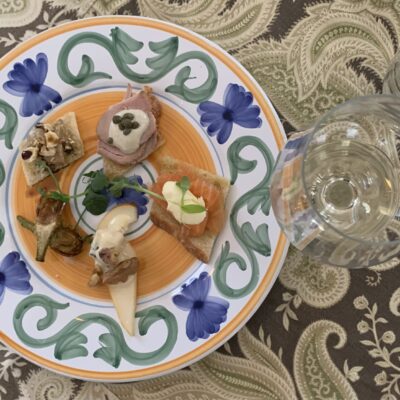 Plate of assorted appetizers with wine