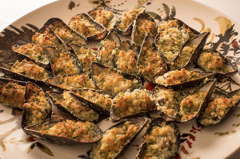 Baked mussels topped with breadcrumbs, garlic, and herbs