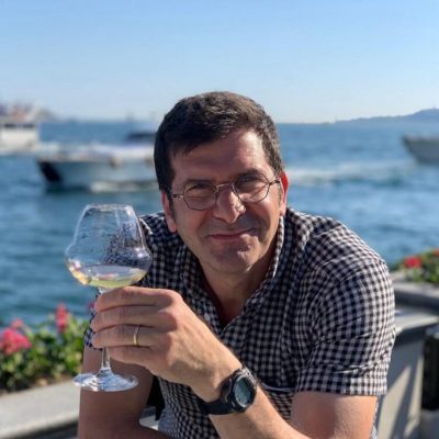 Our host for the event, Sotiris Bafitis, enjoying a glass of wine by the sea.