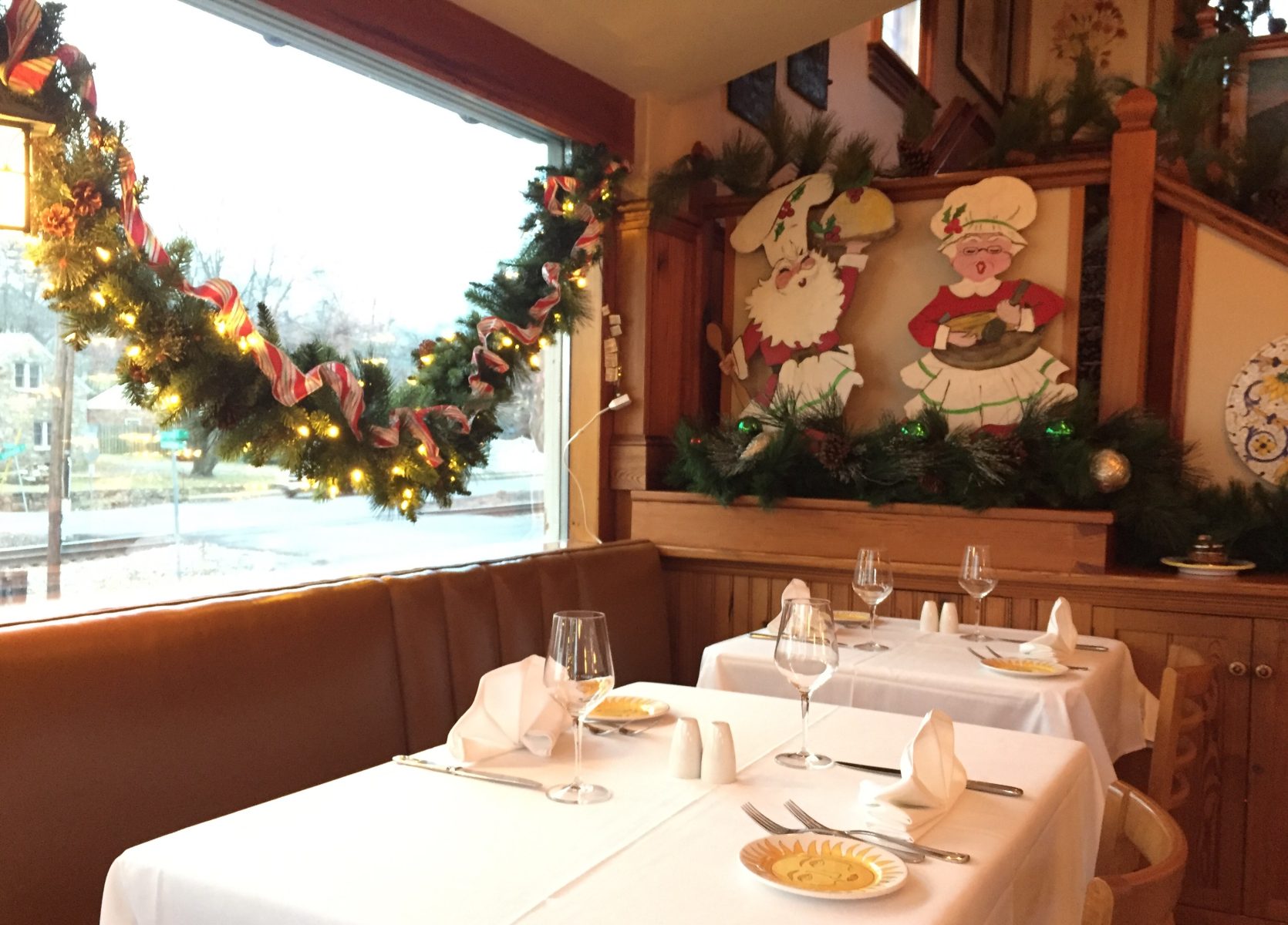 Windows with garland and hand painted Christmas decorations in our dining room