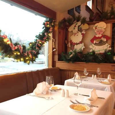 Windows with garland and hand painted Christmas decorations in our dining room